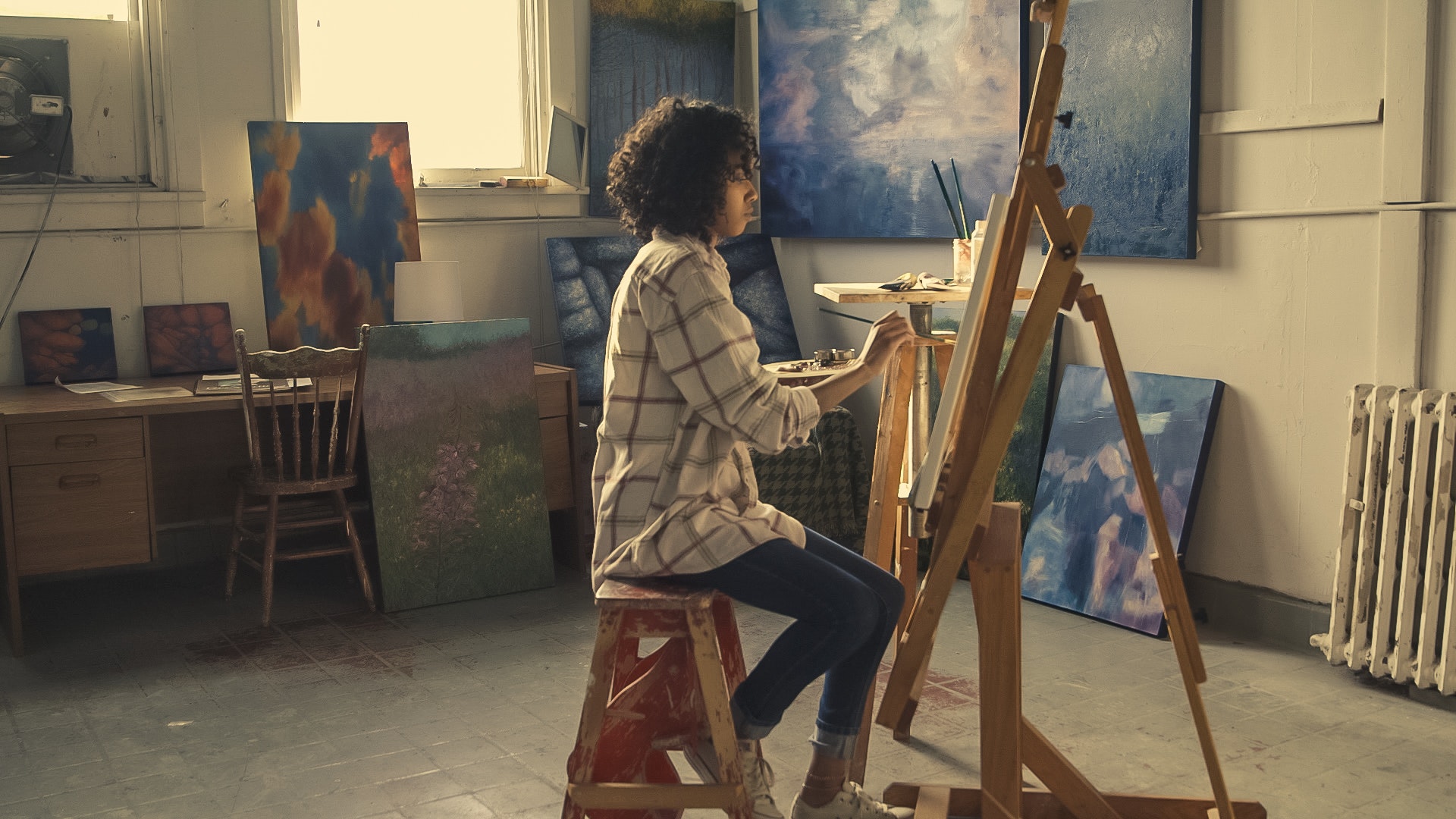 artist painting on a canvas